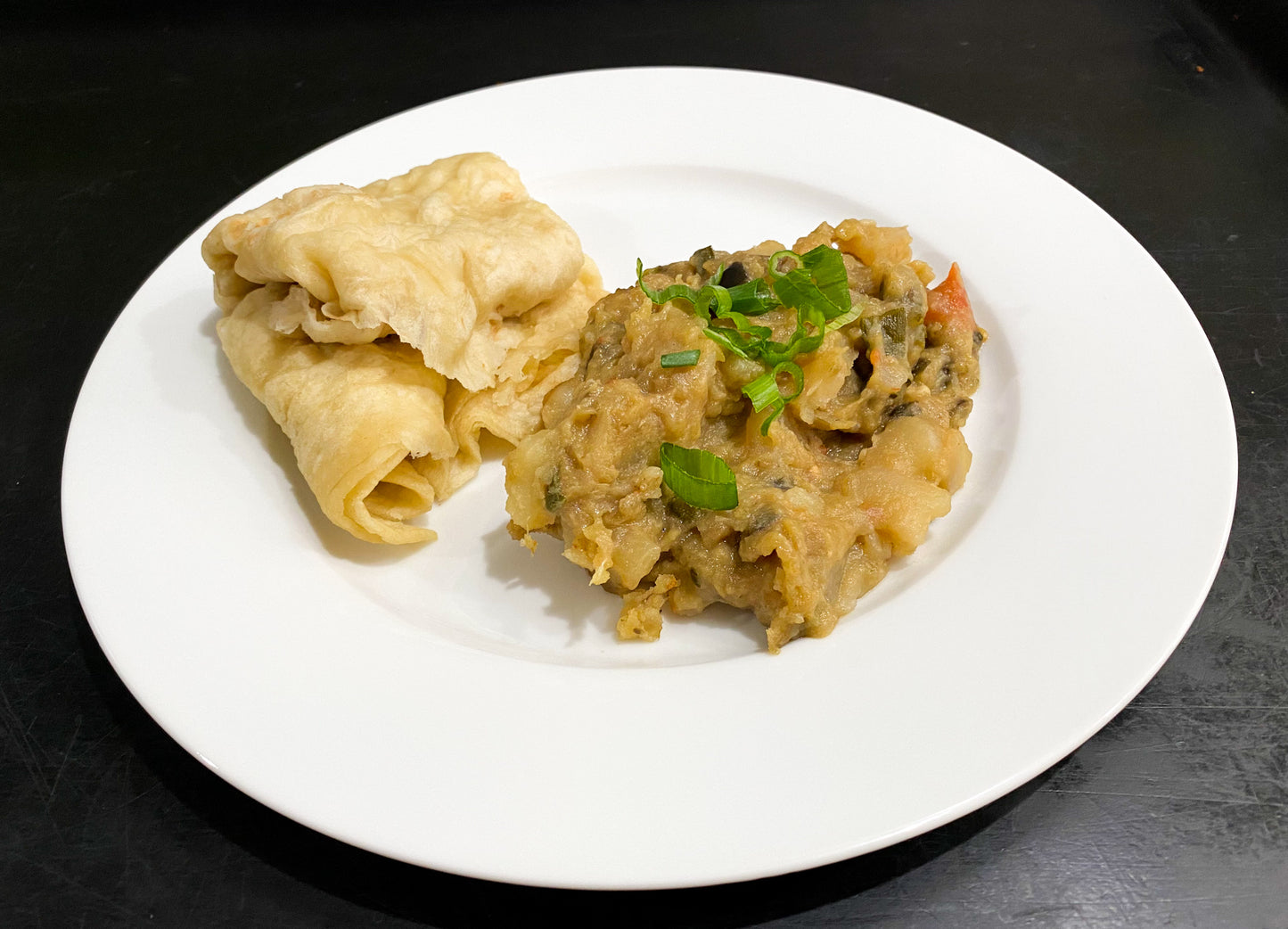 Guyanese fried baigan and potato with garlic and onion