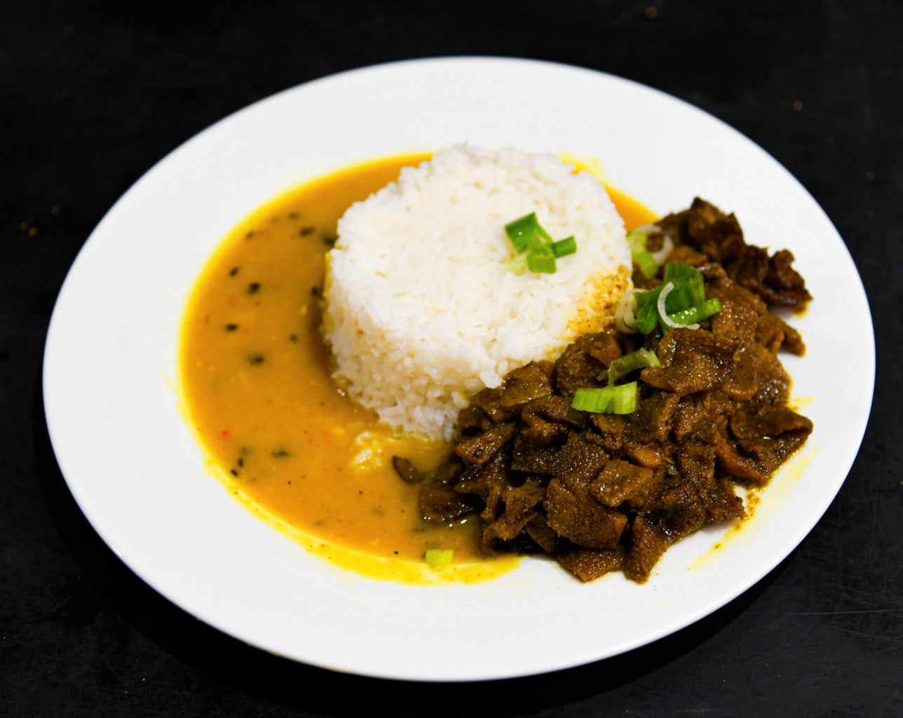 Caribbean dinner bundle with roti, curries, and desserts