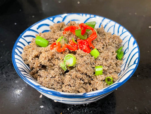 Caribbean coconut choka spread in bowl with fresh herbs